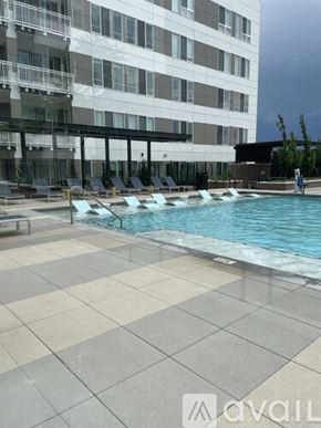 Aurora apartment for rent - A pool area with a tiled floor and a building in the background.