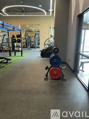 Aurora apartment for rent - A gym with a weight rack and a fan.