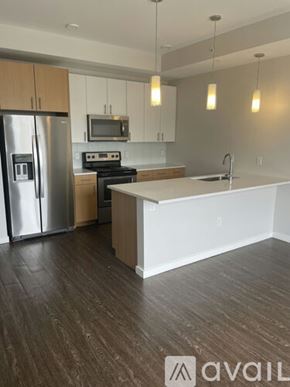 Denver apartment for rent - A kitchen with a refrigerator, stove, and microwave.
