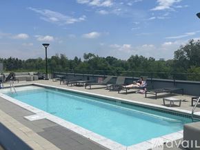 Denver apartment for rent - A pool with people relaxing by it.