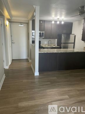 Denver apartment for rent - A kitchen with a refrigerator, cabinets, and a countertop.
