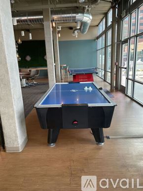 Denver apartment for rent - A pool table in a room with a green wall and a window.
