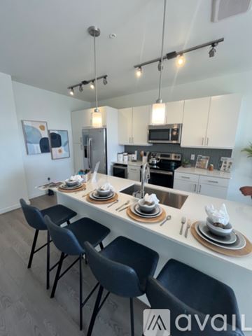 Denver apartment for rent - A kitchen with a table set for four with chairs around it.