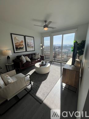 Denver apartment for rent - A living room with a sofa, a chair, a coffee table, and a ceiling fan.