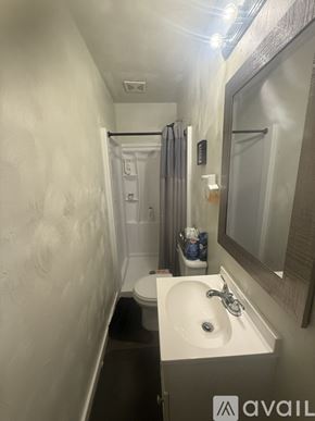 Norfolk house for rent - A room with a ceiling fan and a flag hanging on the wall.