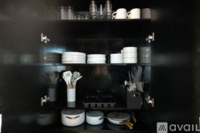 Las Vegas apartment for rent - A kitchen shelf with various dishes and utensils neatly arranged.