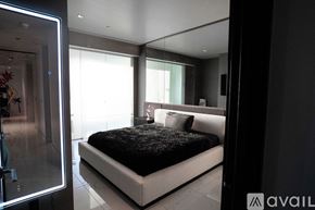 Las Vegas apartment for rent - A bedroom with a large bed and a glass door.