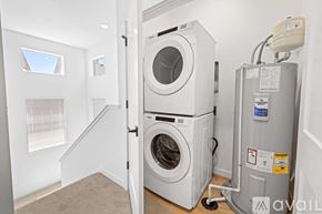 Caldwelll house for rent - A washing machine is in a small room with a carpeted floor.