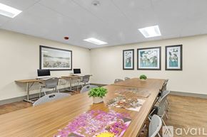 Nashville apartment for rent - A conference room with a long table, chairs, and pictures on the wall.