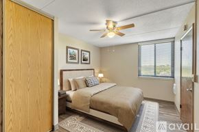 Nashville apartment for rent - A bedroom with a bed, a ceiling fan, and two pictures on the wall.