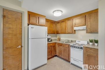 Nashville apartment for rent - A kitchen with wooden cabinets and a white refrigerator.