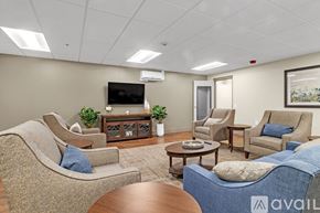 Nashville apartment for rent - A living room with a sofa, armchairs, and a coffee table.