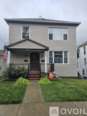 Scranton apartment for rent - A house with a grey facade and a brown door is shown.