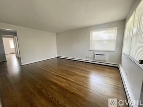 Deer Park apartment for rent - A room with wooden floors and a window with blinds.