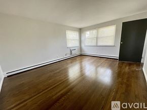 Deer Park apartment for rent - A spacious room with wooden floors and white walls.