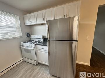 Deer Park apartment for rent - A kitchen with white cabinets and a black countertop.