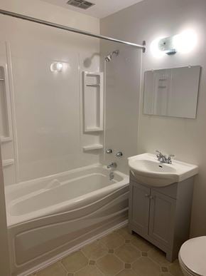 Stellarton apartment for rent - A white bathroom with a sink, toilet, and bathtub.