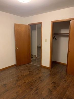 Stellarton apartment for rent - A room with a wooden floor and two open doors.