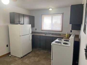 Stellarton apartment for rent - A kitchen with a white fridge and a white stove.