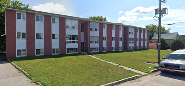 Smiths Falls apartment for rent - A red and white building with a green lawn in front.