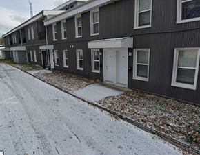 Cornwall apartment for rent - A row of houses with snow on the ground and leaves on the ground.