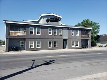 Cornwall apartment for rent - A grey building with a white car parked in front.