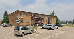 Deep River apartment for rent - A building with a parking lot in front of it.