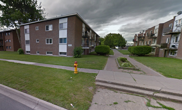 Cornwall apartment for rent - A street view of a residential area with apartment buildings, a fire hydrant, and a sidewalk.