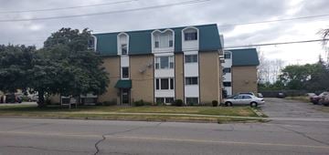 Brockville apartment for rent - A building with a green roof and white trim is in the background.