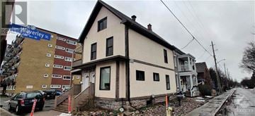 Ottawa apartment for rent - A house with a car parked in front of it.