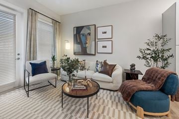Tampa apartment for rent - A living room with a striped carpet and a blue chair.