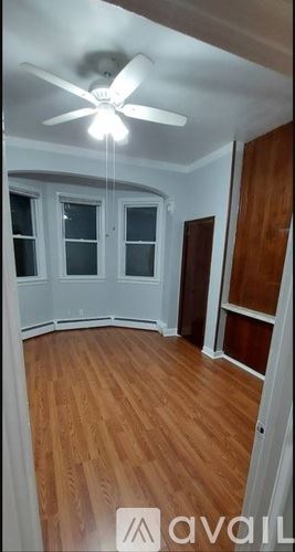 Jersey City apartment for rent - A kitchen with wooden cabinets and black countertops.