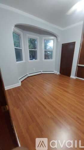Jersey City apartment for rent - A balcony with a white railing and a view of buildings.