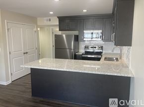 Northport apartment for rent - A kitchen with a granite countertop and stainless steel appliances.