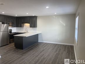 Northport apartment for rent - A kitchen with a black countertop and stainless steel appliances.