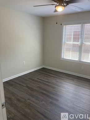Northport apartment for rent - A room with a ceiling fan and a window with blinds.