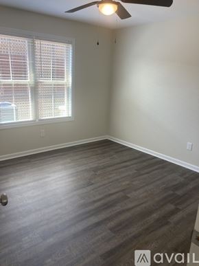 Northport apartment for rent - A room with a ceiling fan and a window with blinds.