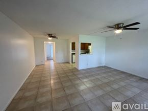 Boca Raton apartment for rent - A spacious room with a ceiling fan and tiled flooring.
