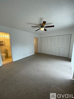 Boca Raton apartment for rent - A room with a ceiling fan and a carpeted floor.