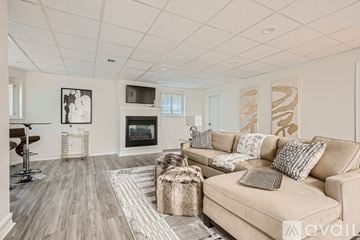 Atlanta house for rent - A living room with a beige couch and a fireplace.