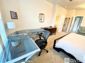 Missouri City house for rent - A bedroom with a bed, desk, and chair.