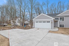 Hudsonville townhouse for rent - A house with a grey garage door is available for sale.