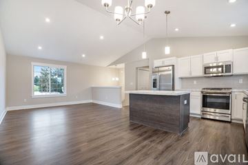 Hudsonville townhouse for rent - A spacious kitchen with a wooden island and stainless steel appliances.