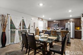 New Kent house for rent - A modern kitchen with a dining table set for four.
