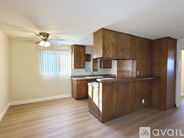 Long Beach apartment for rent - A kitchen area with wooden cabinets and a ceiling fan.