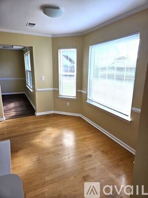 Virginia Beach house for rent - A room with wooden floors and a window with blinds.