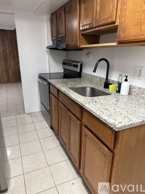 Silver Spring apartment for rent - A kitchen with wooden cabinets and a granite countertop.