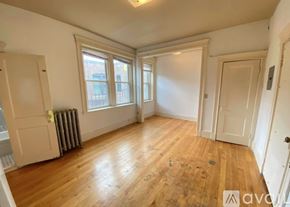 Boston apartment for rent - A room with wooden floors and white walls.