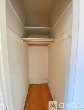 Boston apartment for rent - A white hallway with a wooden floor and a white ceiling.