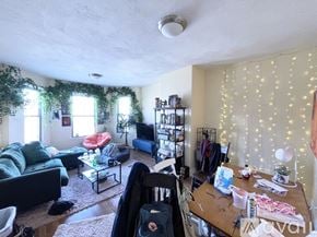 Boston apartment for rent - A living room with a couch, a chair, a coffee table, and a TV.